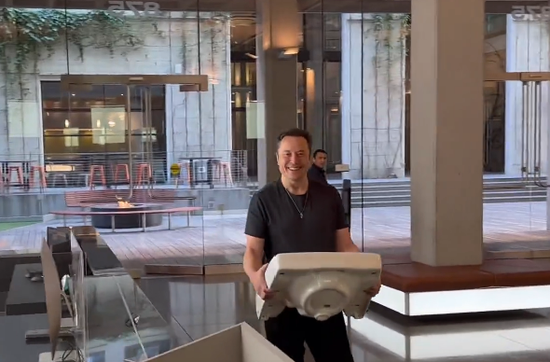 Musk walks into Twitter's corporate headquarters building with a washbasin